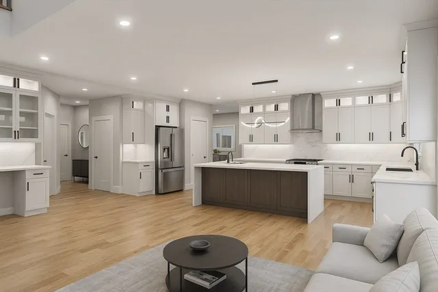 a large kitchen with stainless steel appliances kitchen island a stove a refrigerator a oven and a sink with large countertops