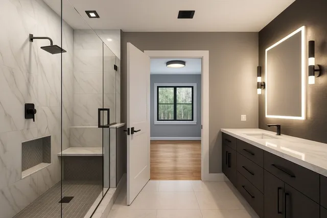 a bathroom with a granite countertop sink a toilet and shower
