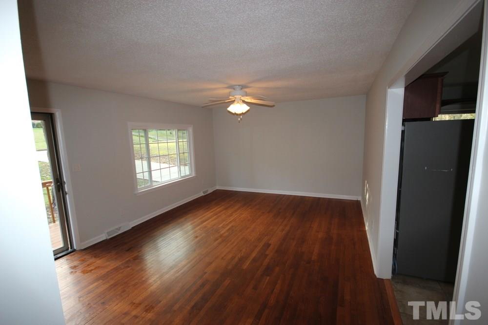 1725 Euclid Road Durham, NC 27713 - Photo 4 of 23 an empty room with wooden floor and windows