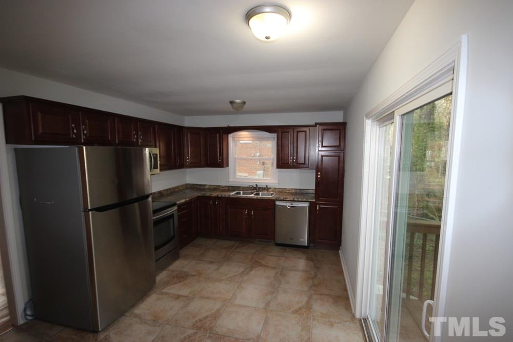 1725 Euclid Road Durham, NC 27713 - Photo 5 of 23 a kitchen with a refrigerator and a sink