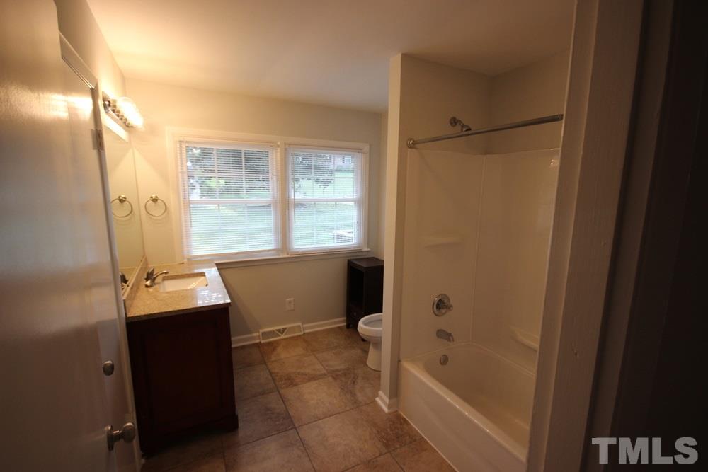 1725 Euclid Road Durham, NC 27713 - Photo 9 of 23 a bathroom with a bathtub sink vanity and window