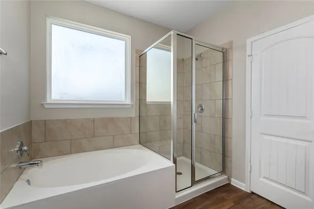 a bathroom with a bathtub and a shower