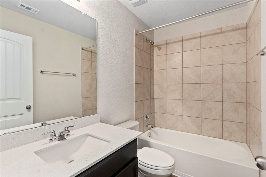 4217 Porter Farm Road Georgetown, TX 78628 - Photo 15 of 17 a bathroom with a sink a toilet and shower