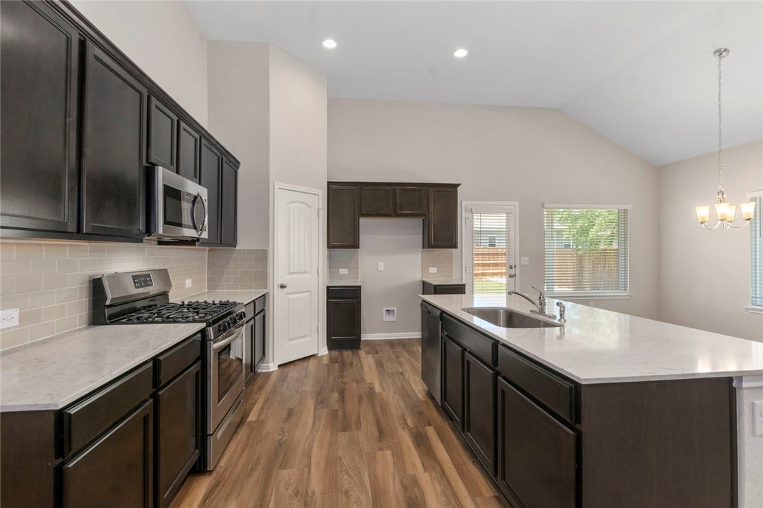 4217 Porter Farm Road Georgetown, TX 78628 - Photo 5 of 17 a kitchen with a sink stove top oven and refrigerator