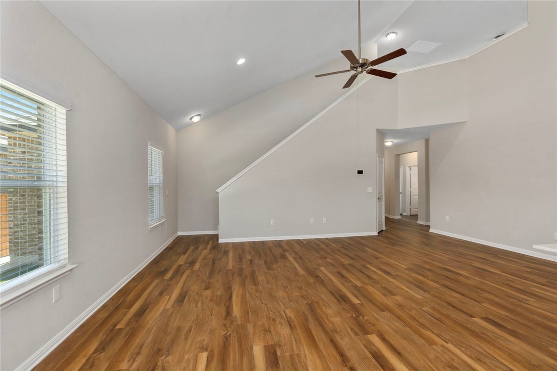 4217 Porter Farm Road Georgetown, TX 78628 - Photo 7 of 17 a view of empty room with wooden floor and fan