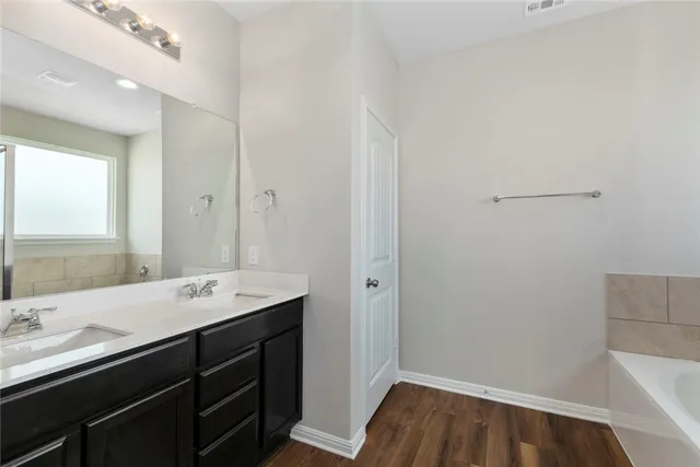 a bathroom with a sink a mirror and vanity