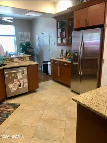 a kitchen with stainless steel appliances granite countertop a stove a sink and a refrigerator