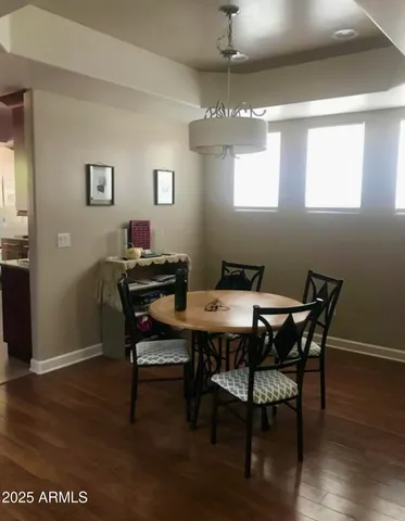 a view of a dining room with furniture wooden floor and a chandelier