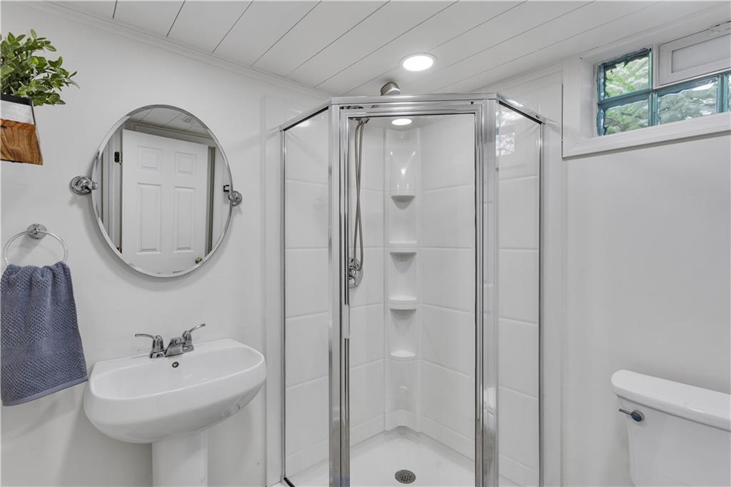 360 Orr Avenue Apollo, PA 15613 - Photo 19 of 24 a bathroom with a sink a mirror a glass door a shower and a mirror