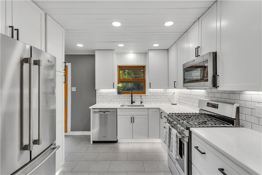360 Orr Avenue Apollo, PA 15613 - Photo 8 of 24 a kitchen with a sink stove and refrigerator
