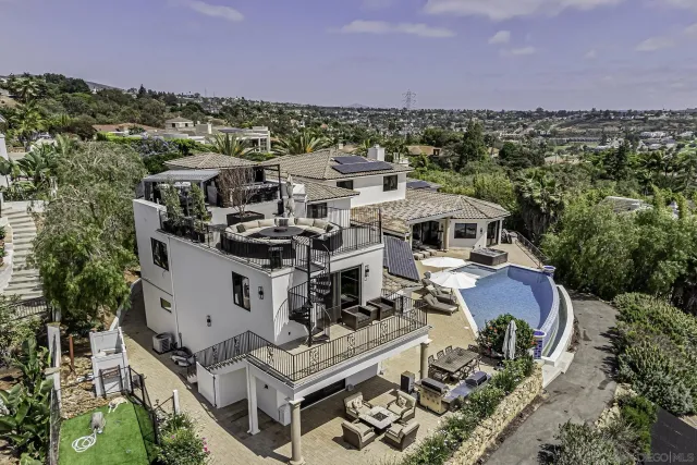 a view of a roof deck with couches and sky view