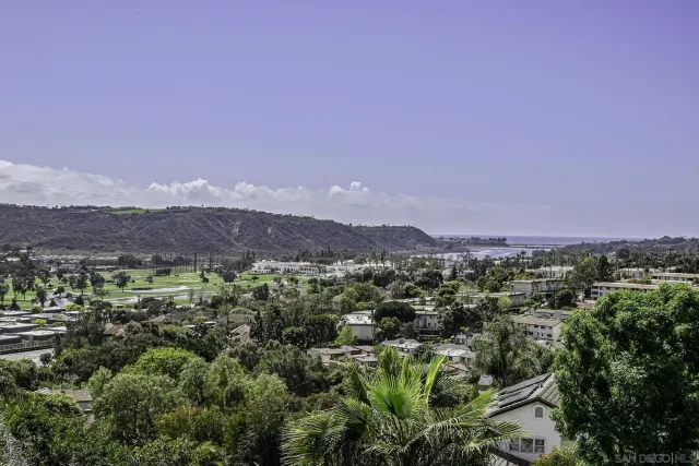 a front view of a house with a garden and trees