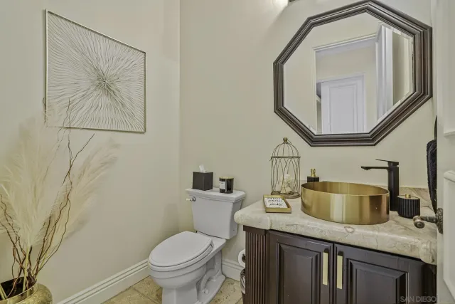 a spacious bathroom with a granite countertop sink a large mirror and a bathtub