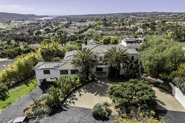 a view of a house with swimming pool and sitting area