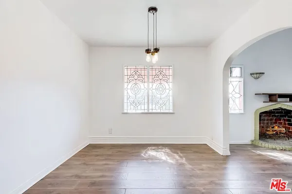 a view of a room with wooden floor and cabinet