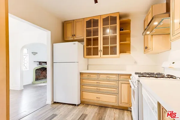 a kitchen with granite countertop cabinets stainless steel appliances and a sink