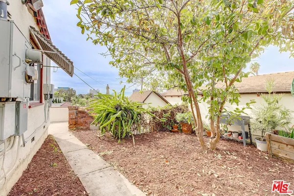 a view of a pathway of a yard of the house