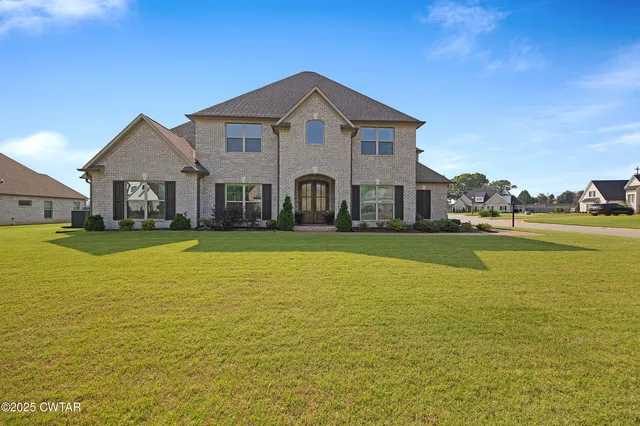 a front view of a house with a big yard