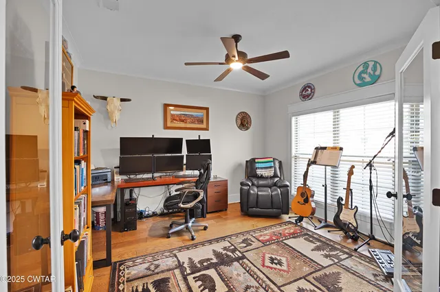 a view of a workspace with furniture and a window