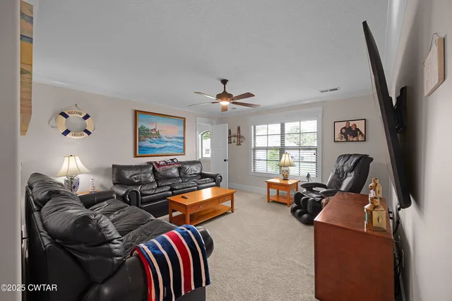 a living room with furniture fireplace and a large window