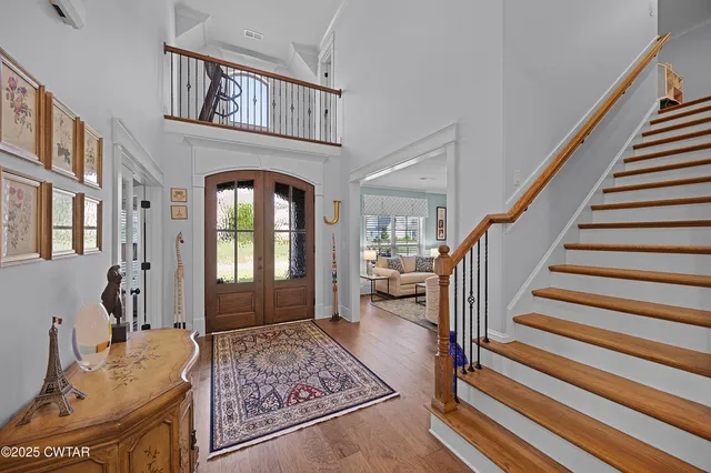 a view of entryway and hall with wooden floor