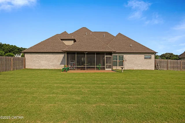 an aerial view of a city with lots of residential buildings ocean and mountain view in back