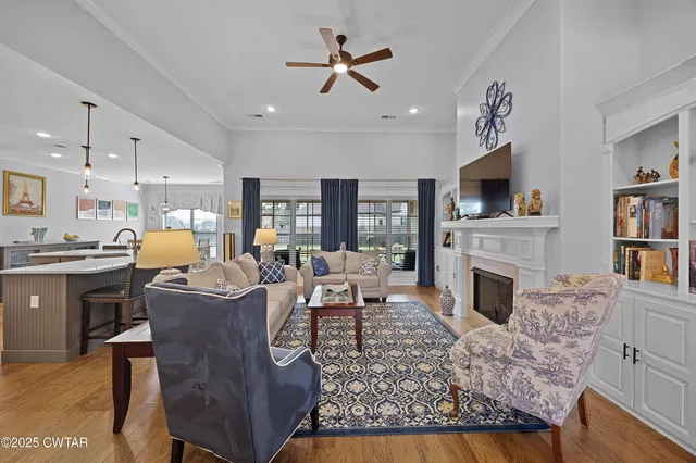a living room with furniture a fireplace and a flat screen tv