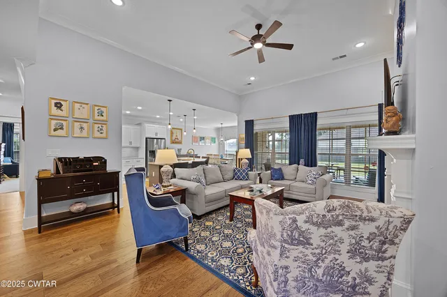 a living room with fireplace furniture and a wooden floor