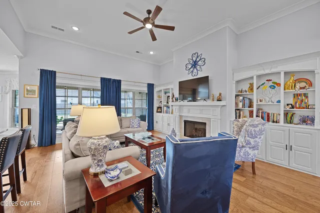 a living room with furniture fireplace and window