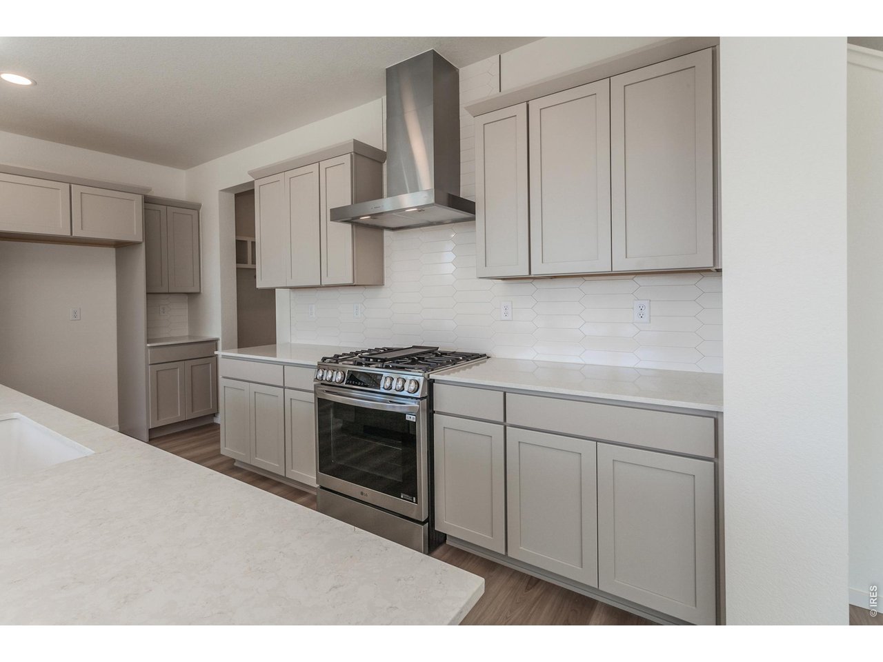 6079 Red Barn Road Timnath, CO 80547 - Photo 12 of 44 Gas range and hood