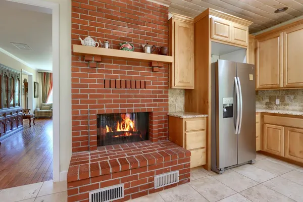a kitchen with granite countertop a sink and a refrigerator