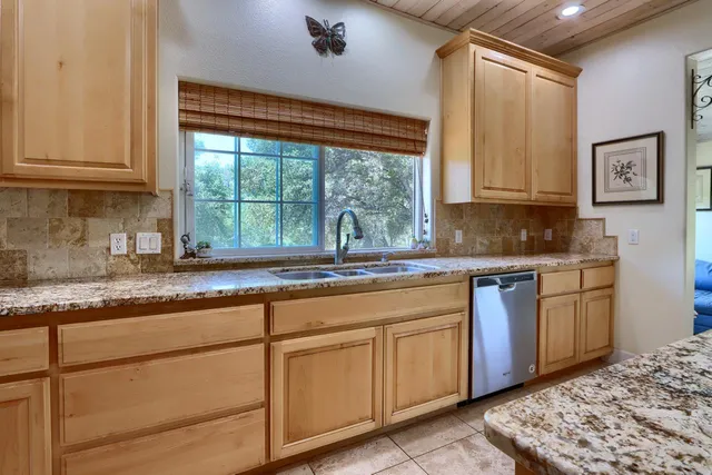 a kitchen sink sitting next to a window