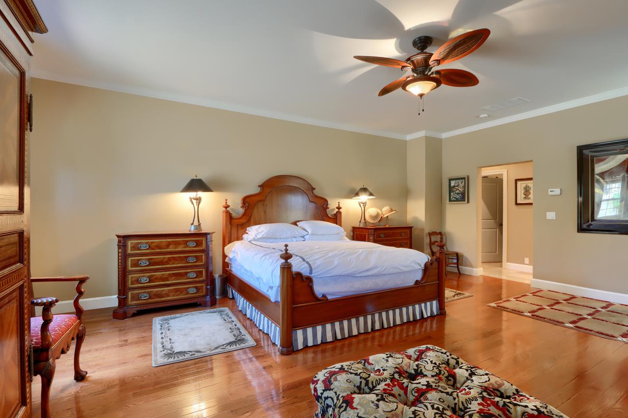 7551 Hunters Valley Road Mariposa, CA 95338 - Photo 34 of 78 a bedroom with a bed and a chandelier