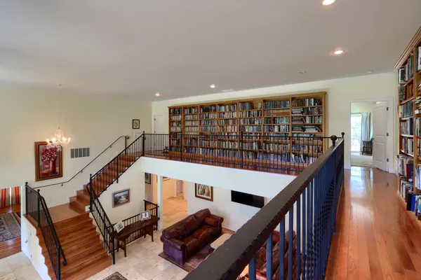an aerial view of a house with a yard and large trees