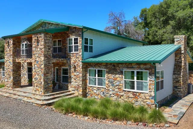 a front view of a house with a garden