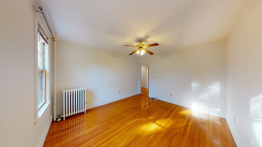 32 Sidlaw Road, Unit 7 Boston, MA 02135 - Photo 6 of 10 a view of a room with a ceiling fan and wooden floor