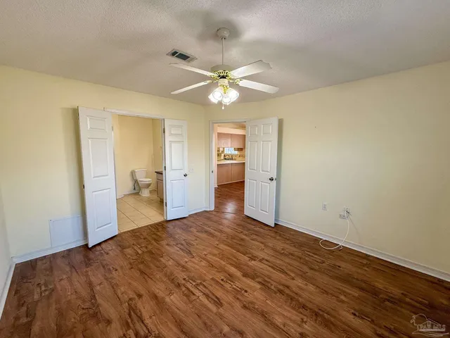 a view of a bedroom with a sink and a chandelier fan