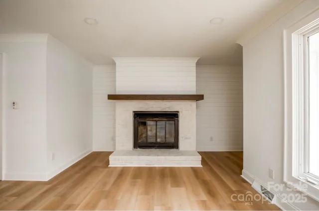 a room with a fireplace and a window