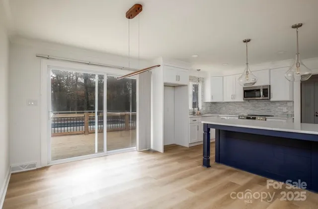 a kitchen with kitchen island a sink stainless steel appliances and cabinets