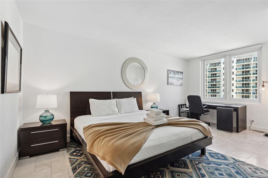 2301 Collins Avenue, Unit 1015 Miami Beach, FL 33139 - Photo 7 of 15 a bedroom with a bed and a large window