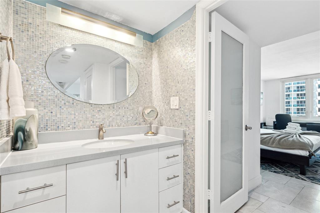 2301 Collins Avenue, Unit 1015 Miami Beach, FL 33139 - Photo 9 of 15 a en suite bathroom with a double vanity sink and a mirror