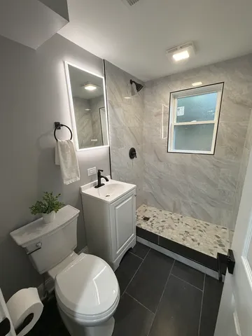 a bathroom with a sink toilet and shower