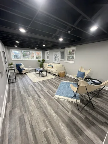a living room with lots of furniture and a wooden floor