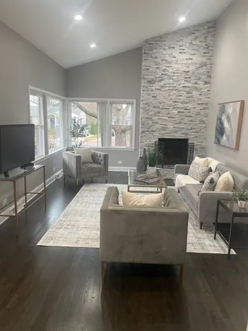 a living room with furniture a fireplace and a flat screen tv