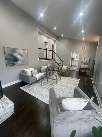a living room with furniture and wooden floor