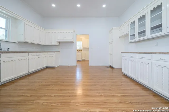 a view of a kitchen with wooden floor and a sink