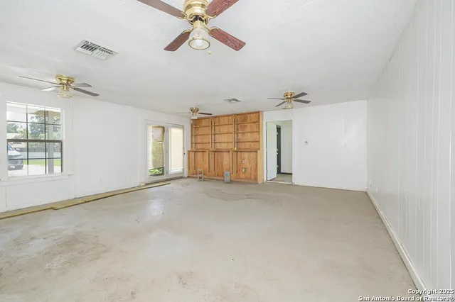 a front view of a house with a yard and a garden