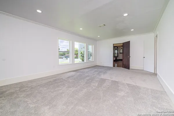 an empty room with windows and closet