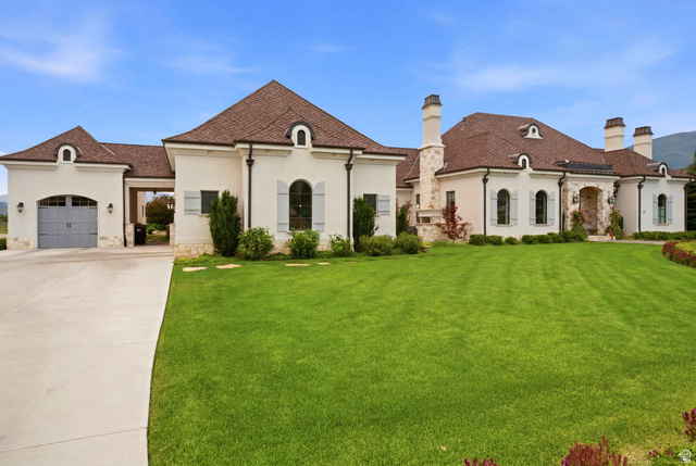 71 Farm Road Midway, UT 84049 - Photo 85 of 92 Expansive property featuring a stucco exterior with stone accents, a multi-gabled roof, arched windows with light-colored shutters, and multiple chimneys