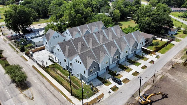 an aerial view of multiple houses with yard